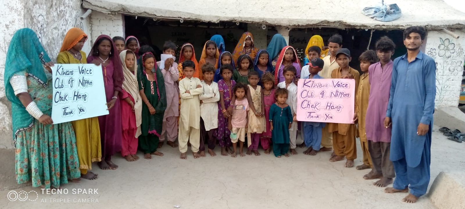 Community holding a thank-you message to the Kiwanis Voices Club of Nippon